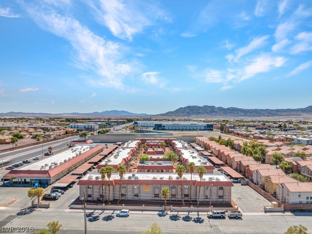 4300 N Lamont Street, #291, Las Vegas, NV 89115 Desert mountains rise behind this multi-family residential community under a bright blue sky.