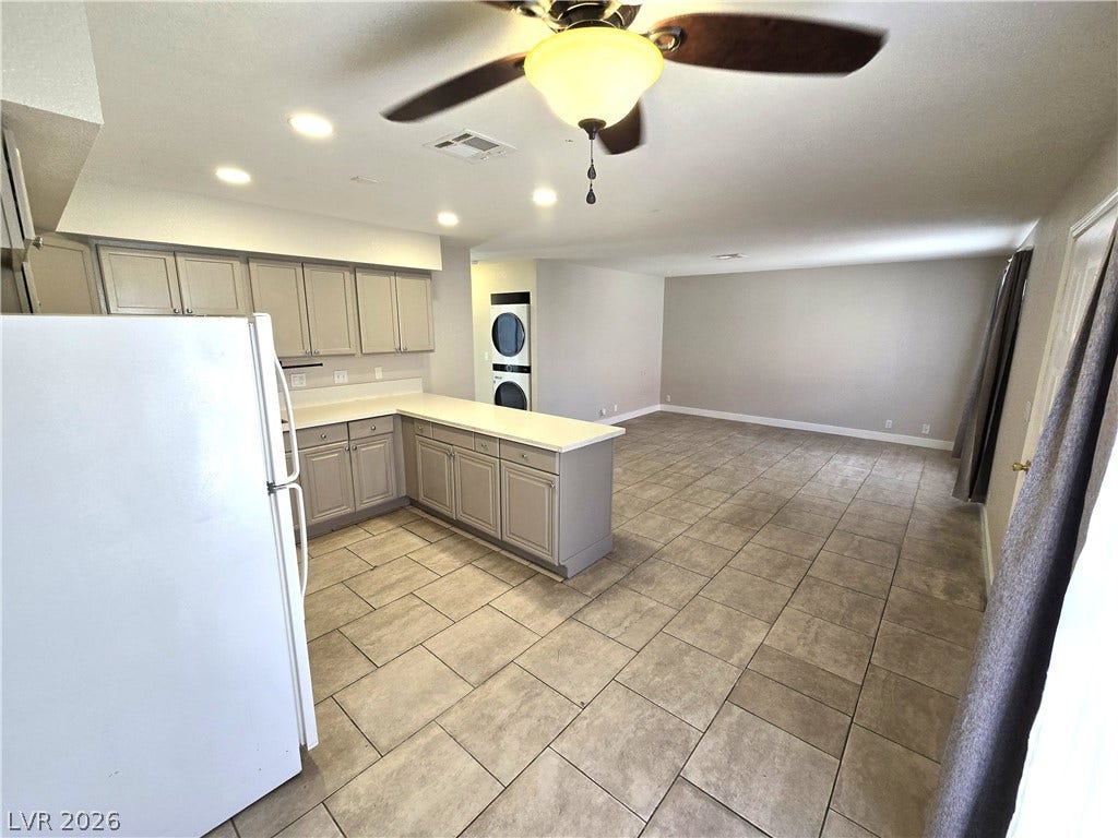 4300 N Lamont Street, #291, Las Vegas, NV 89115 Tiled flooring flows seamlessly from the open kitchen into the expansive living area.