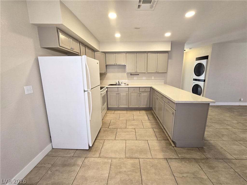4300 N Lamont Street, #291, Las Vegas, NV 89115 Tiled flooring and solid-surface countertops anchor this functional kitchen layout.