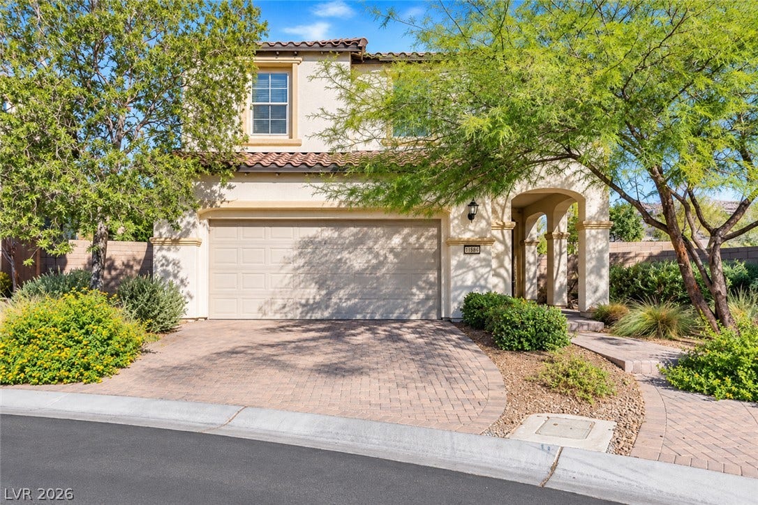 11886 Corenzio Avenue, Las Vegas, NV 89138 Spanish tile accents and a paved driveway enhance this welcoming two-story exterior.