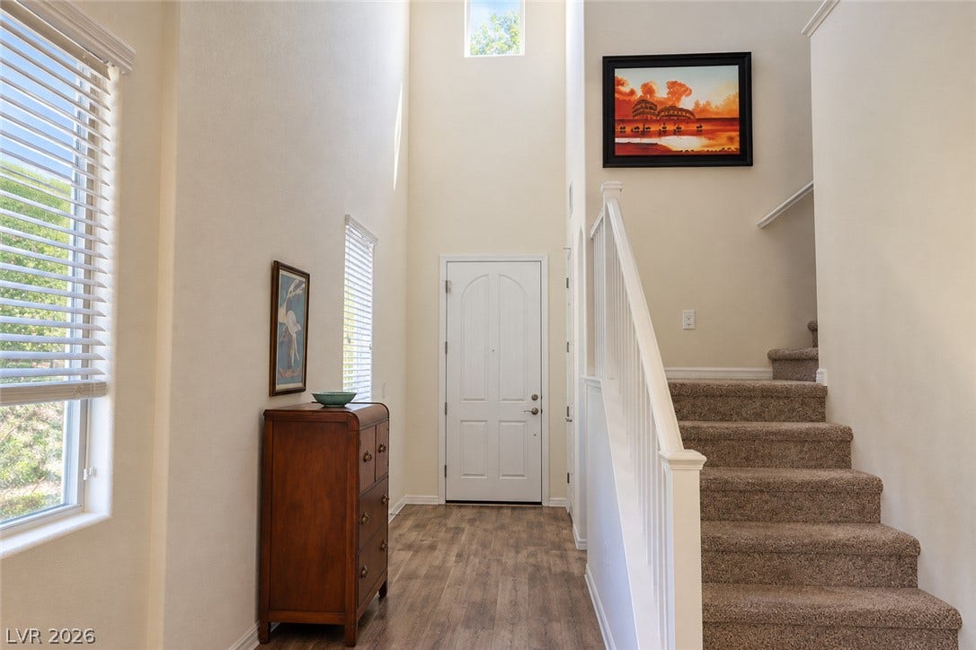 11886 Corenzio Avenue, Las Vegas, NV 89138 High ceilings and a carpeted staircase define this welcoming entry hallway.