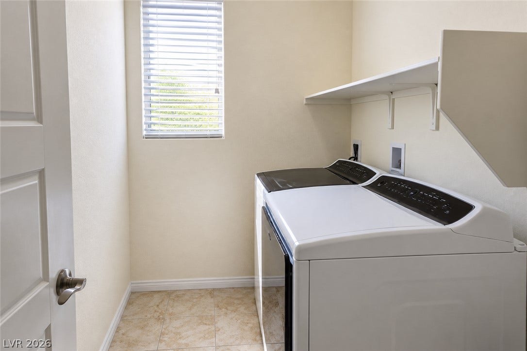 11886 Corenzio Avenue, Las Vegas, NV 89138 Natural light fills this practical utility space featuring tiled flooring and overhead built-in shelving. Whirlpool Washer and Dryer.