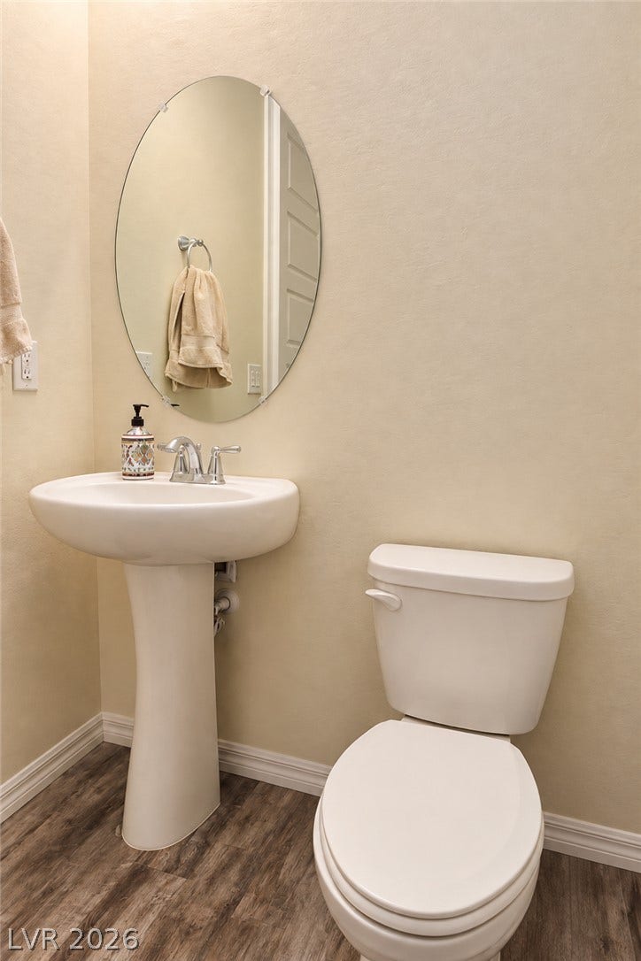 11886 Corenzio Avenue, Las Vegas, NV 89138 Rich wood-look flooring sets a warm foundation in this classic half bath.