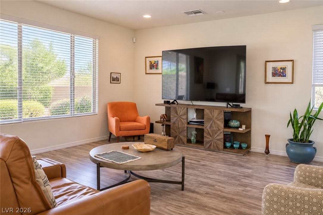 11886 Corenzio Avenue, Las Vegas, NV 89138 Generous windows fill this living area with natural light highlighting the wood-look flooring.