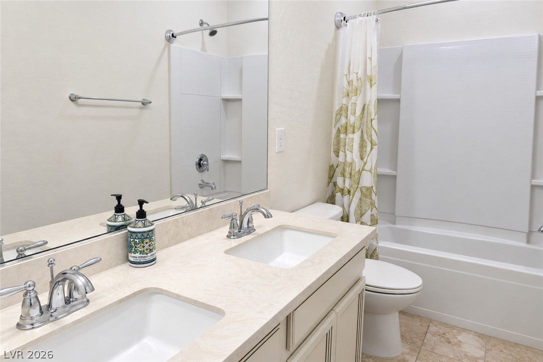 11886 Corenzio Avenue, Las Vegas, NV 89138 Clean lines and a spacious dual vanity highlight this classic bathroom design.