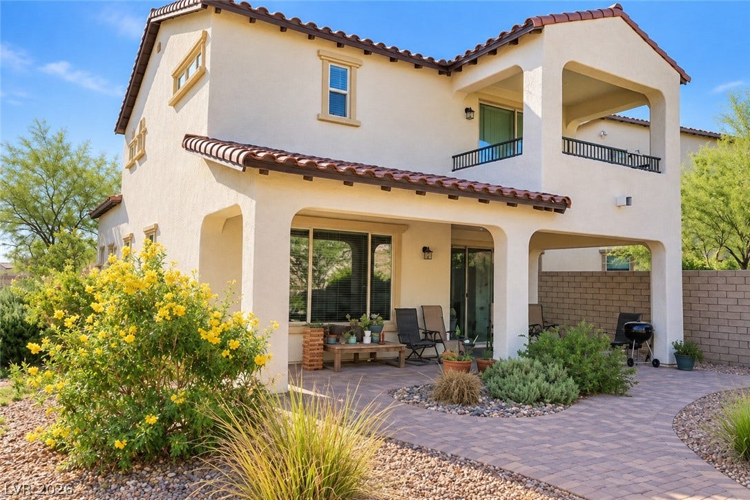 11886 Corenzio Avenue, Las Vegas, NV 89138 A spacious covered patio and upper-level balcony look out over the paved backyard terrace.