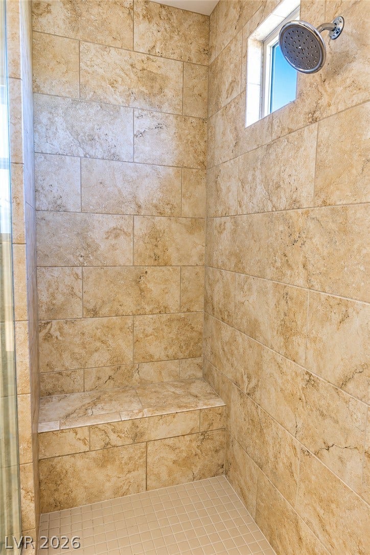 11886 Corenzio Avenue, Las Vegas, NV 89138 Textured tile walls and a built-in bench elevate this walk-in shower design.