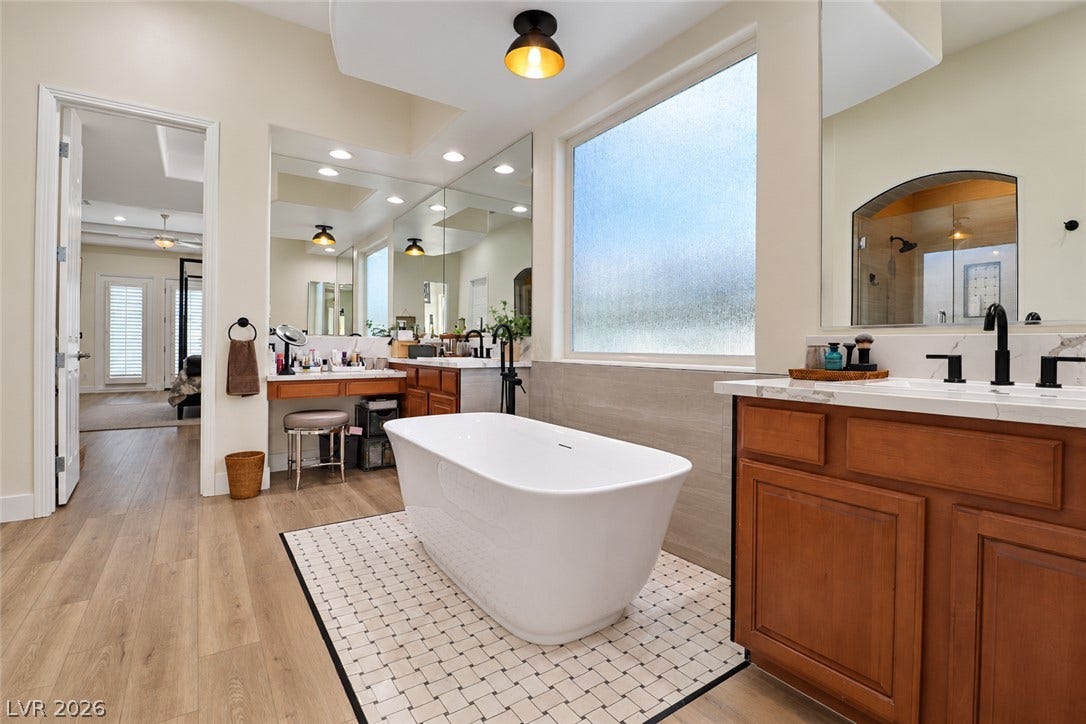 10 Caminito Amore, Henderson, NV 89011 Warm wood cabinetry and a freestanding tub create a tranquil, spa-like atmosphere.