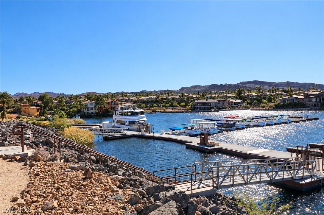 10 Caminito Amore, Henderson, NV 89011 Plentiful boat docks line the sparkling blue water set against a desert mountain backdrop.