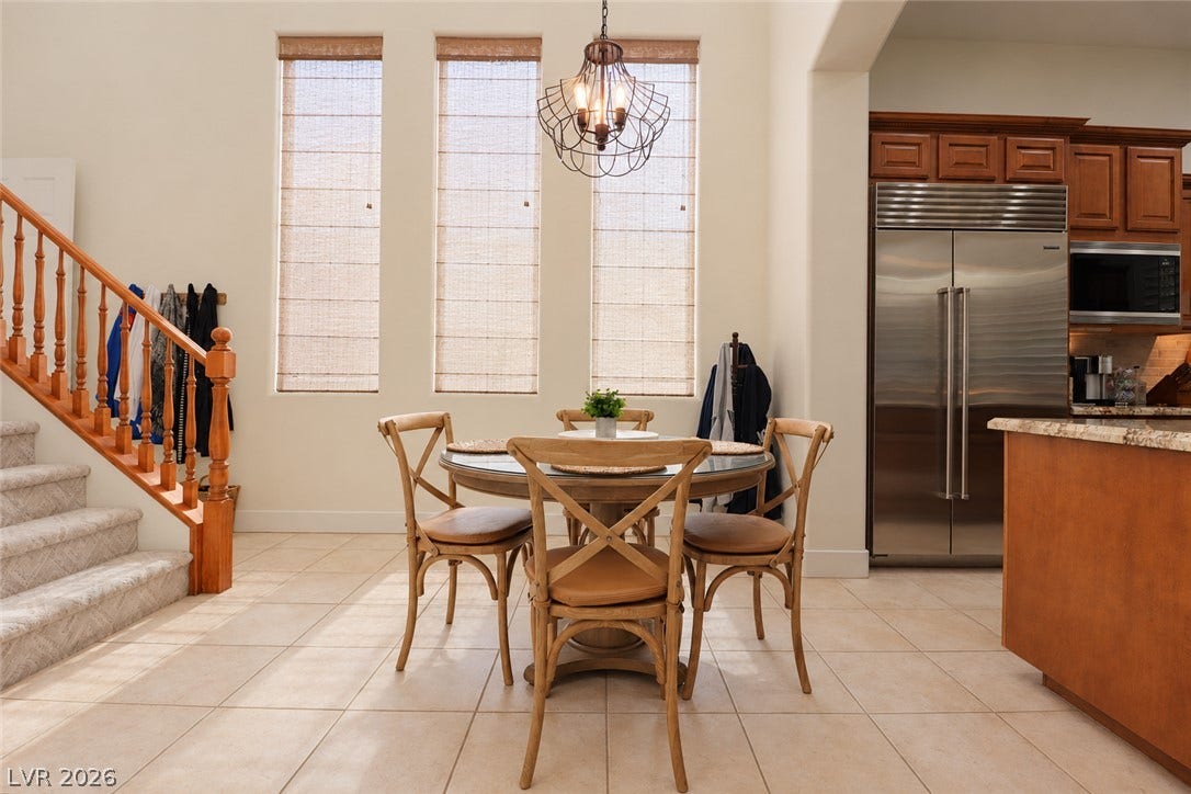 10 Caminito Amore, Henderson, NV 89011 Sunlight streams through towering windows into this inviting breakfast area with tile flooring.