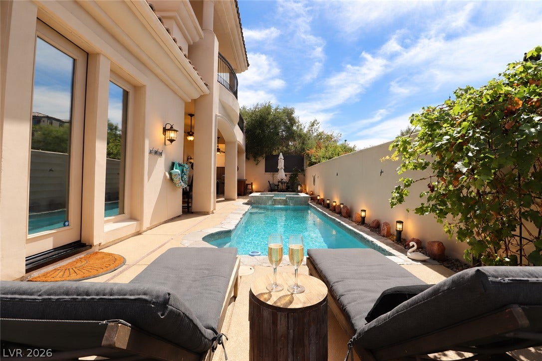 10 Caminito Amore, Henderson, NV 89011 A private swimming pool and integrated spa sit nestled alongside this elegant stucco home.