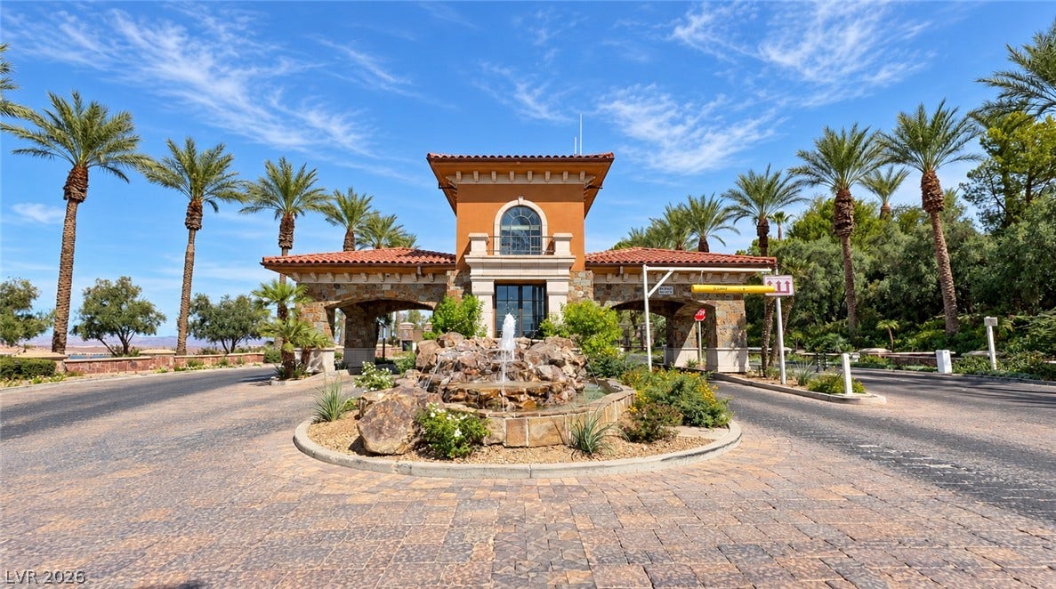 10 Caminito Amore, Henderson, NV 89011 A grand, gated entrance features classic stone columns and a cascading stone water fountain.