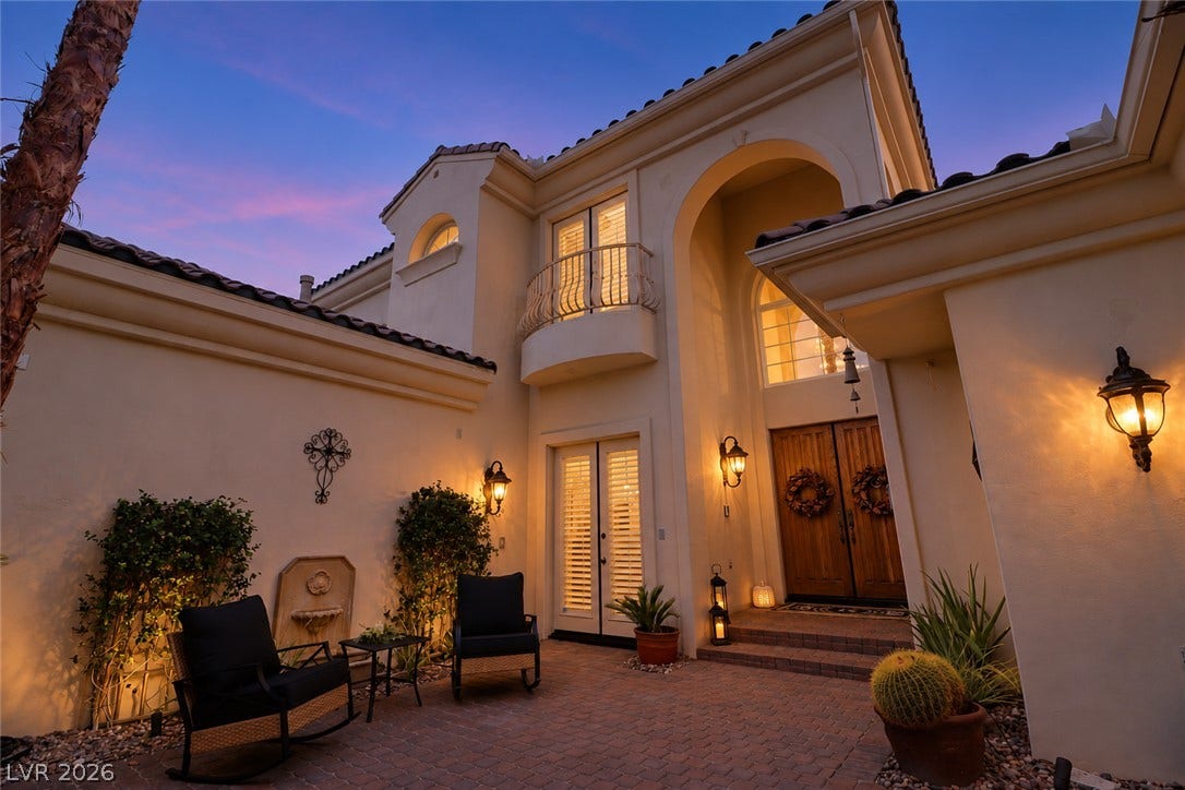10 Caminito Amore, Henderson, NV 89011 Warm exterior lighting accentuates the elegant entry archway and paved private courtyard.