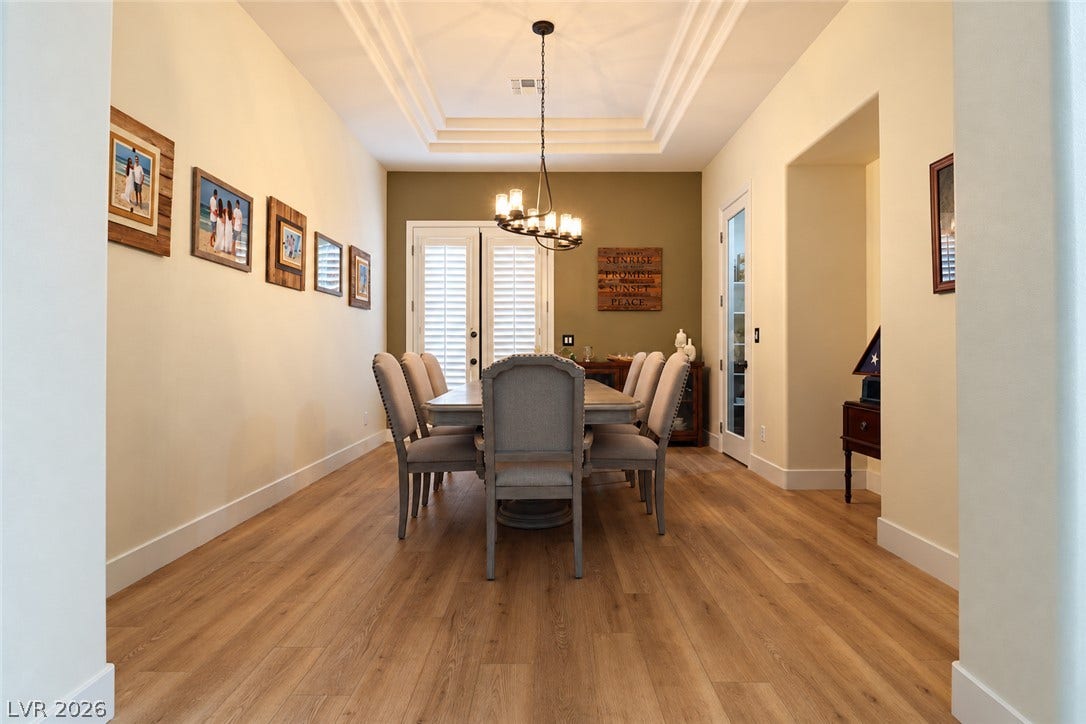 10 Caminito Amore, Henderson, NV 89011 Gleaming hardwood floors and a tiered tray ceiling define this elegant formal dining area.