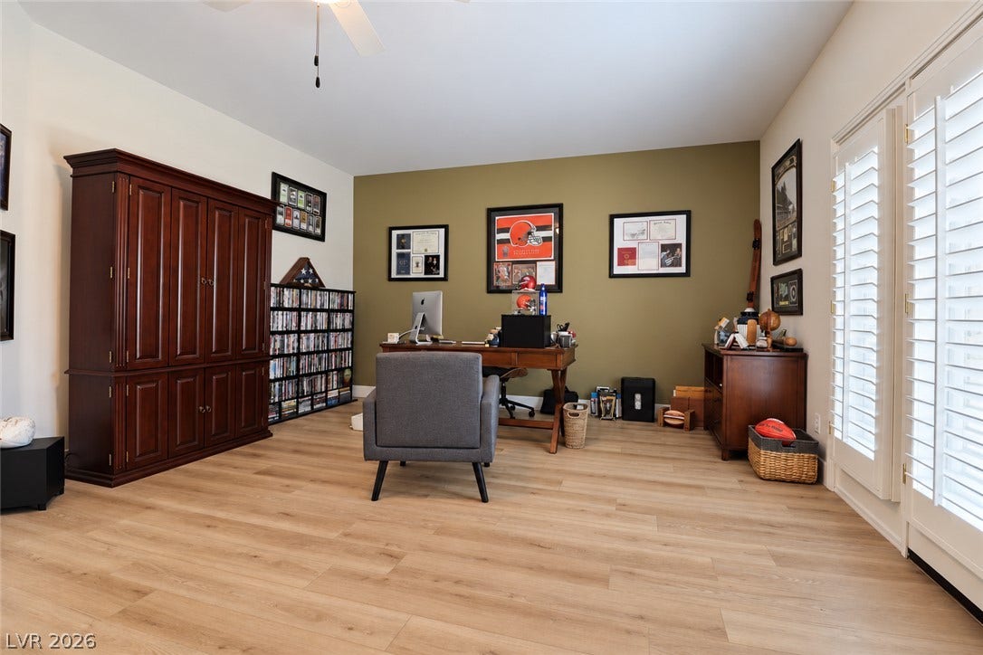 10 Caminito Amore, Henderson, NV 89011 Smooth wood-style flooring anchors this versatile workspace featuring double doors with integrated plantation shutters.