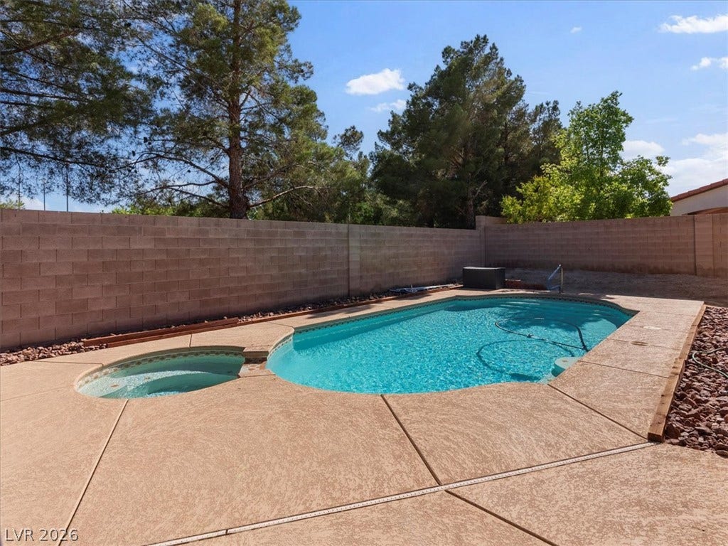 1217 Silent Sunset Avenue, North Las Vegas, NV 89084 An inviting backyard pool and spa are enclosed by a privacy wall.