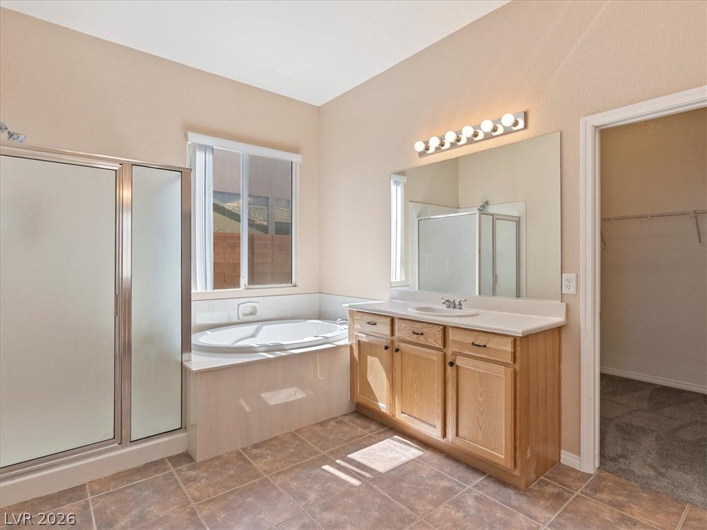 1217 Silent Sunset Avenue, North Las Vegas, NV 89084 A spacious bathroom layout features a deep soaking tub and adjacent walk-in closet.