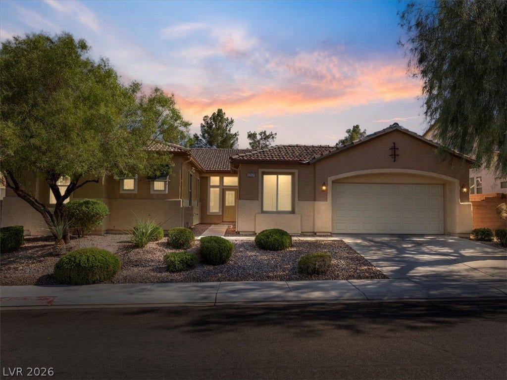 1217 Silent Sunset Avenue, North Las Vegas, NV 89084 Desert landscaping and a tiled roof define the curb appeal of this single-story home.