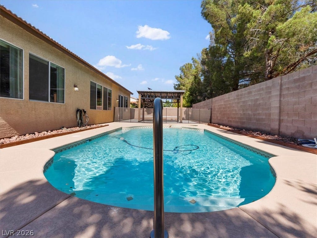 1217 Silent Sunset Avenue, North Las Vegas, NV 89084 An inviting swimming pool sits within a private backyard enclosed by solid block fencing.