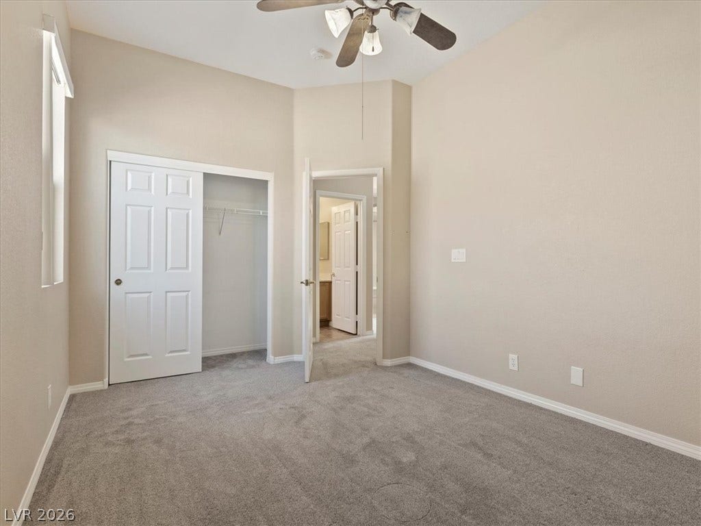 1217 Silent Sunset Avenue, North Las Vegas, NV 89084 A spacious bedroom offers plush neutral carpeting and a convenient closet.
