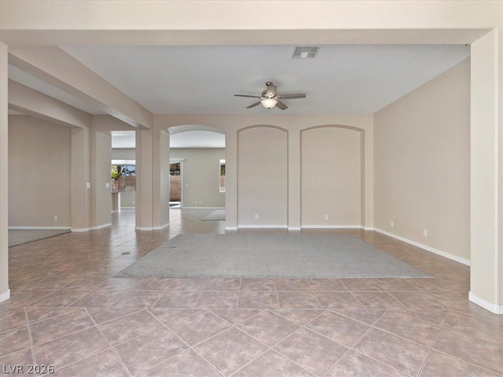 1217 Silent Sunset Avenue, North Las Vegas, NV 89084 Tile flooring and structural arches define this versatile open living space.