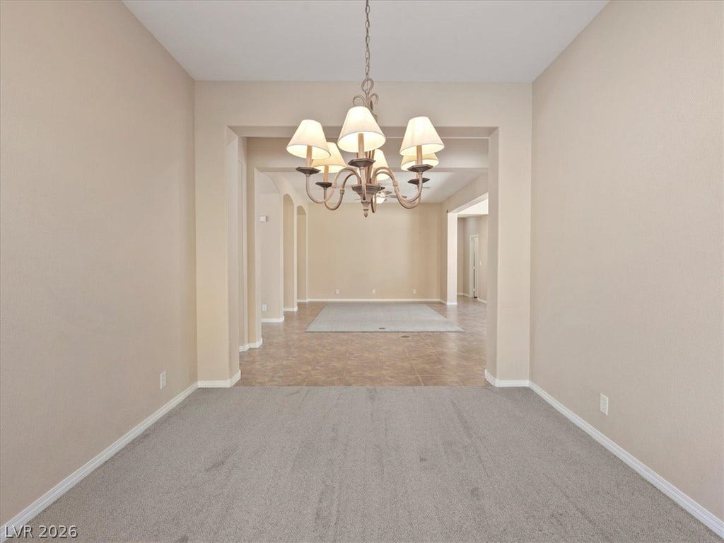 1217 Silent Sunset Avenue, North Las Vegas, NV 89084 Clean lines and transition flooring define this open dining space looking into the living area.