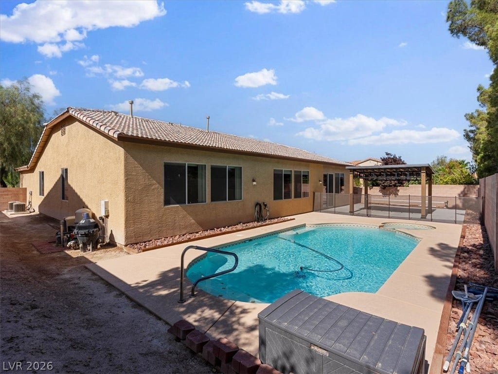 1217 Silent Sunset Avenue, North Las Vegas, NV 89084 A sparkling in-ground pool serves as the centerpiece of this spacious desert backyard.
