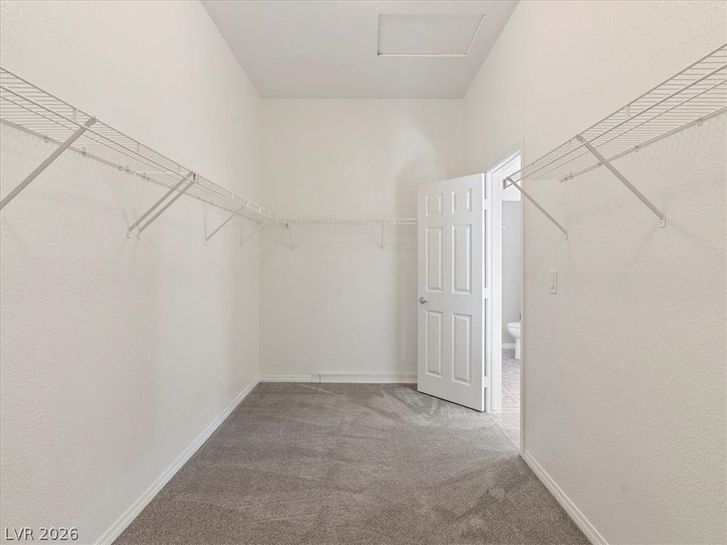 1217 Silent Sunset Avenue, North Las Vegas, NV 89084 Ample wire shelving lines this functional closet space completed by soft neutral carpeting.
