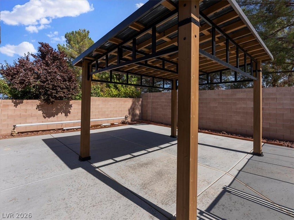 1217 Silent Sunset Avenue, North Las Vegas, NV 89084 A sturdy timber pavilion covers a spacious concrete patio within a fully walled backyard.