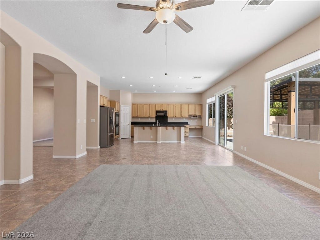 1217 Silent Sunset Avenue, North Las Vegas, NV 89084 An open floorplan seamlessly connects the airy living area to the spacious kitchen beyond.