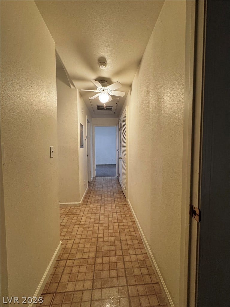 1900 N Torrey Pines Drive, #101, Las Vegas, NV 89108 Tiled flooring runs the length of this central hallway leading to adjacent rooms.