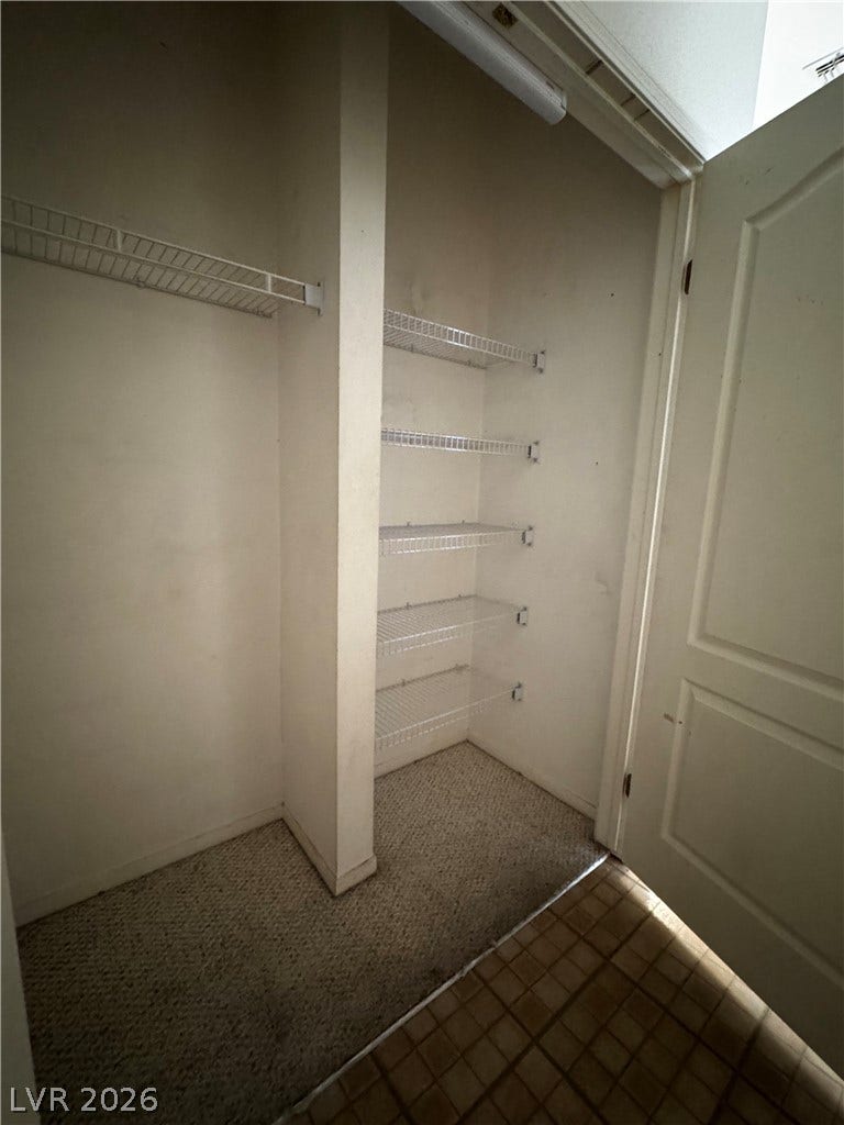 1900 N Torrey Pines Drive, #101, Las Vegas, NV 89108 Built-in wire shelving optimizes storage space in this carpeted closet.
