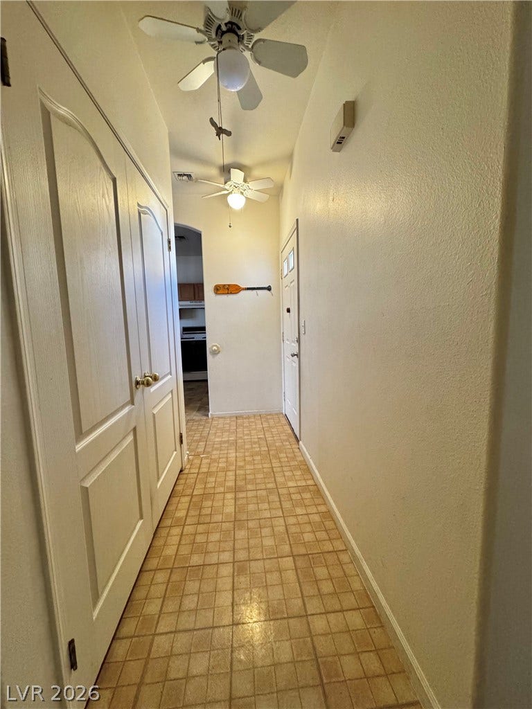 1900 N Torrey Pines Drive, #101, Las Vegas, NV 89108 Tiled flooring and neutral walls guide the way through this functional home entrance.