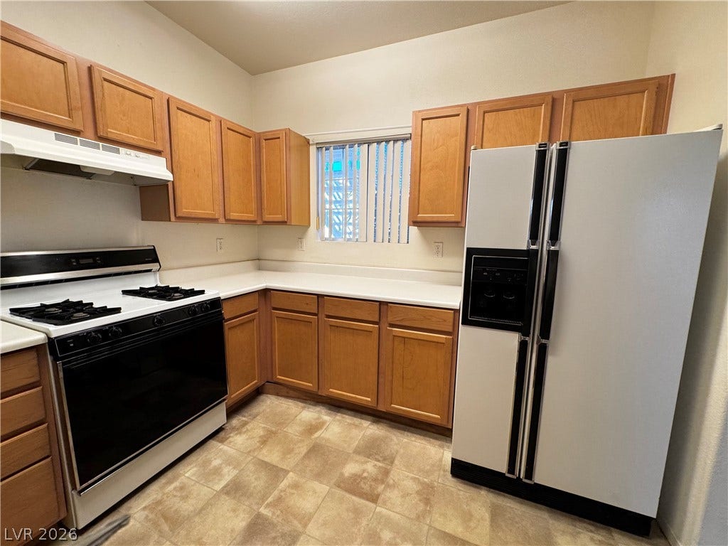 1900 N Torrey Pines Drive, #101, Las Vegas, NV 89108 Warm wood cabinetry and durable countertops define this functional cooking space.