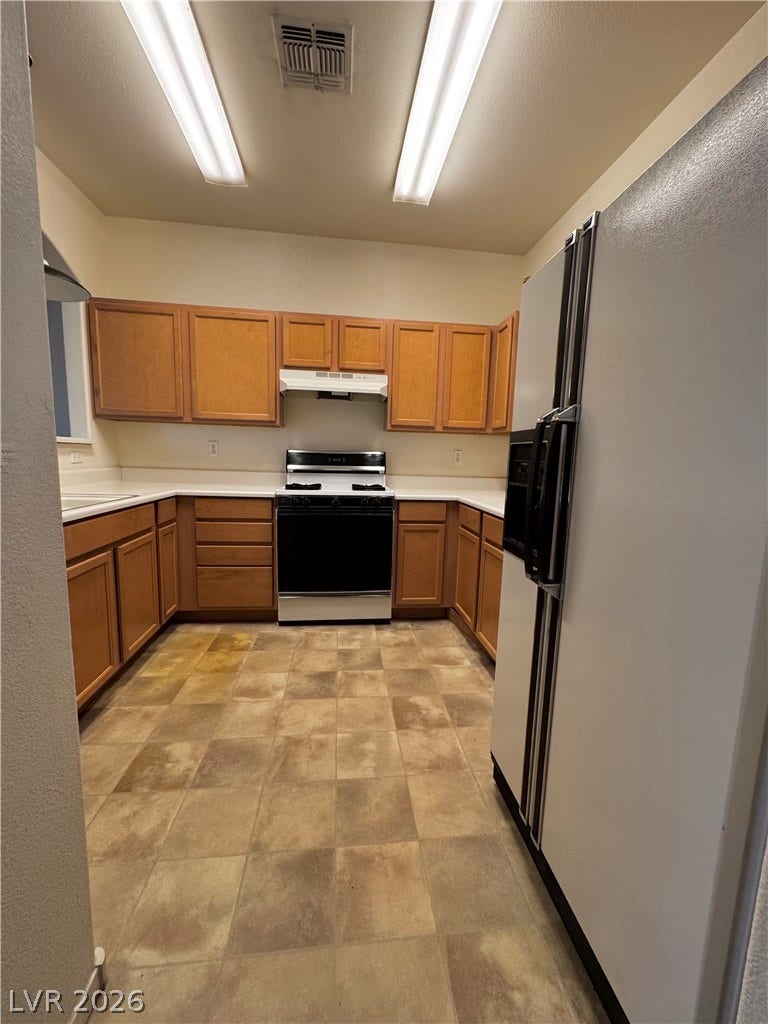 1900 N Torrey Pines Drive, #101, Las Vegas, NV 89108 Functional kitchen design showcases abundant cabinetry and expansive counter space.