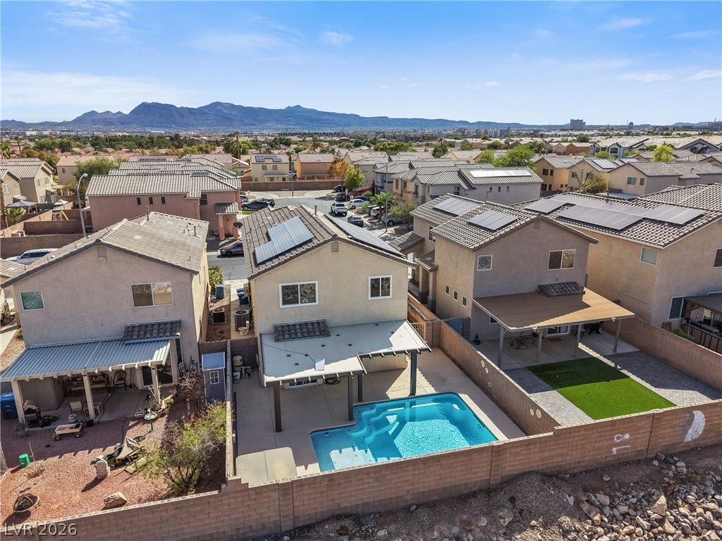 7066 Shimmering Avenue, Henderson, NV 89011 Distant mountain views frame this suburban neighborhood complete with private backyards and a swimming pool.