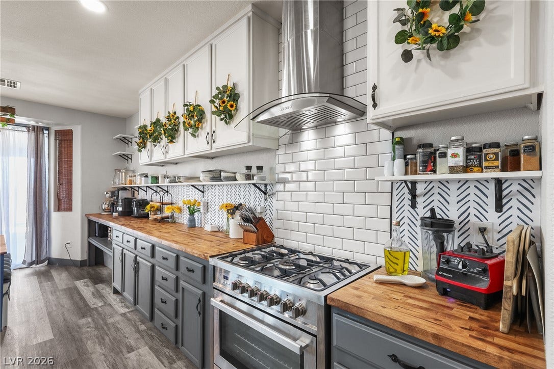 7066 Shimmering Avenue, Henderson, NV 89011 Butcher block countertops complement white cabinetry and a professional-grade gas range in this kitchen.