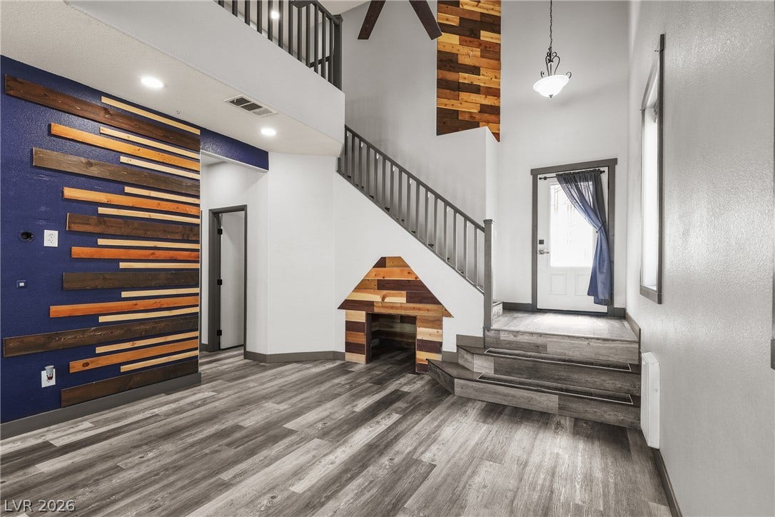 7066 Shimmering Avenue, Henderson, NV 89011 Dramatic vaulted ceilings and custom wood plank accents frame this striking multi-level entryway.