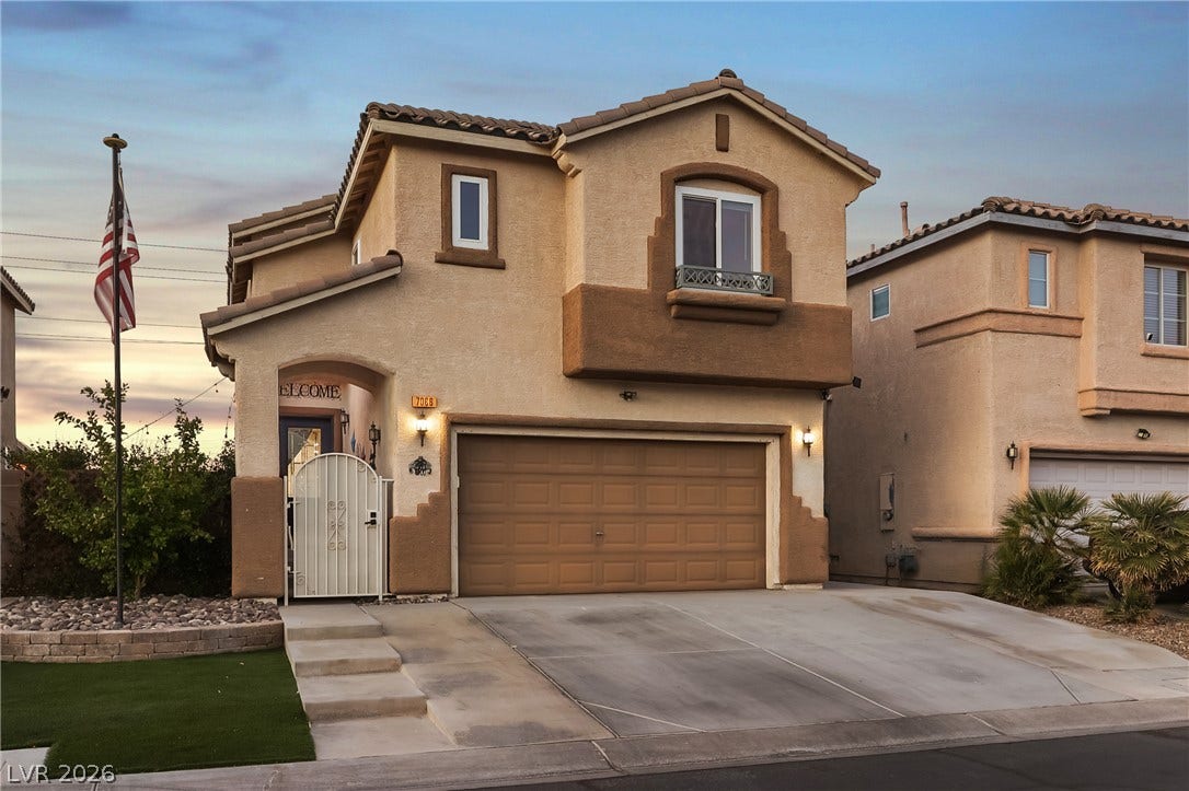 7066 Shimmering Avenue, Henderson, NV 89011 Stucco exterior elements pair with a tiled roof and concrete driveway.