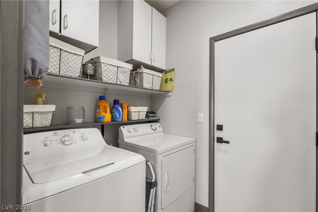 7066 Shimmering Avenue, Henderson, NV 89011 Functional cabinetry and overhead shelving maximize utility inside this streamlined laundry space located downstairs.