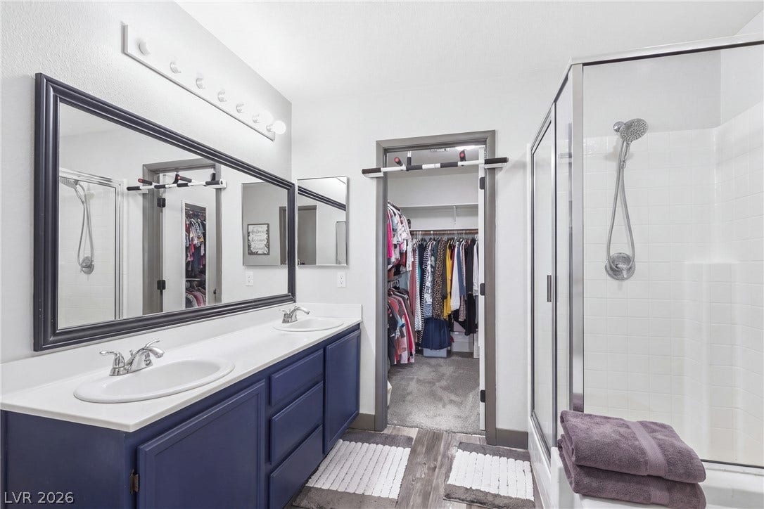 7066 Shimmering Avenue, Henderson, NV 89011 A modern double vanity bathroom leads directly into a spacious walk-in closet.