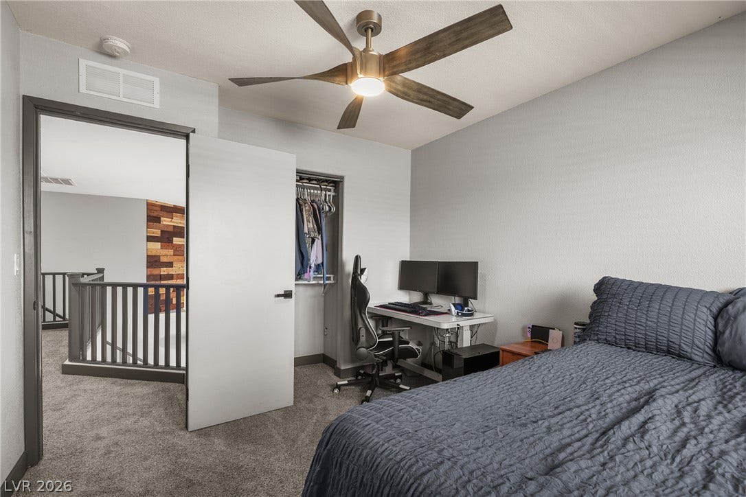 7066 Shimmering Avenue, Henderson, NV 89011 Plush carpeting anchors this comfortable bedroom with direct access to the upper-level landing.