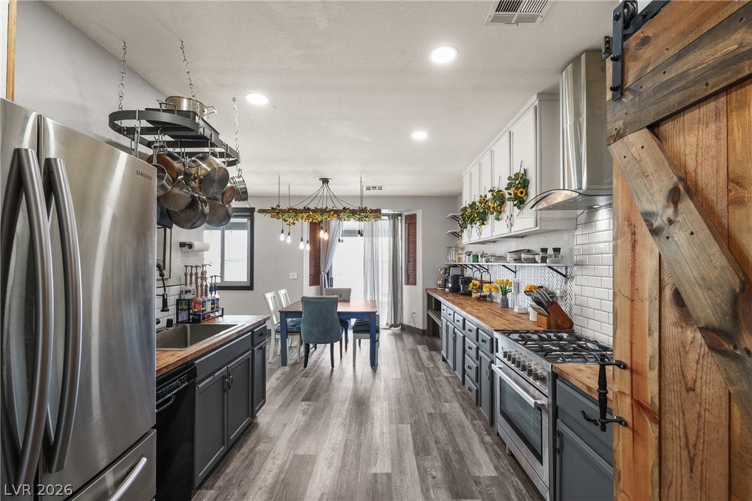 7066 Shimmering Avenue, Henderson, NV 89011 Gleaming wood floors anchor this updated kitchen featuring ample cabinetry and professional-grade appliances.