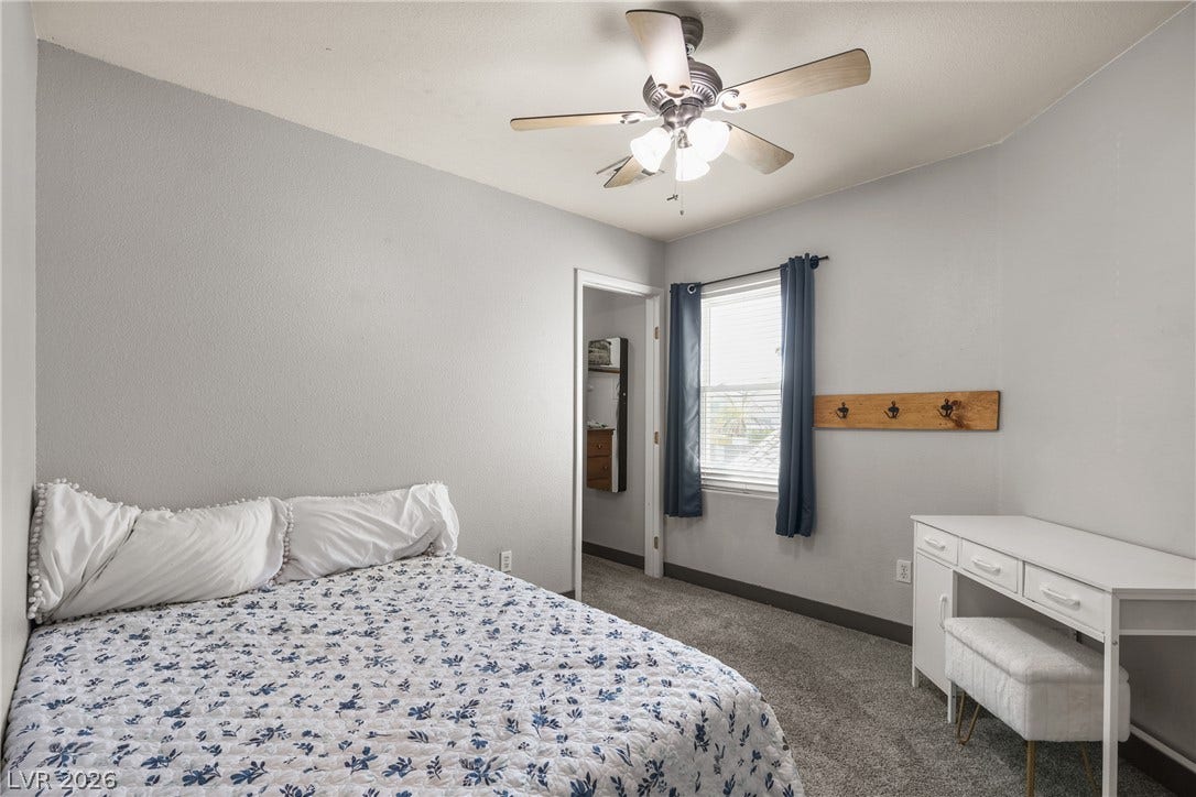 7066 Shimmering Avenue, Henderson, NV 89011 Plush carpeting and abundant natural light create a welcoming and comfortable retreat.