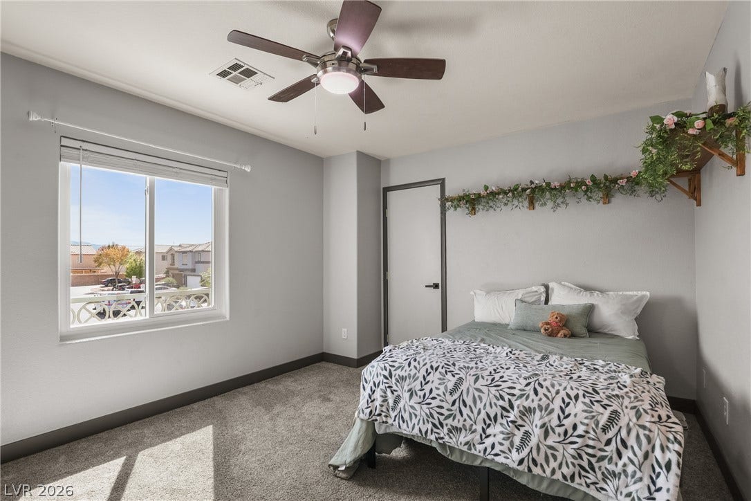 7066 Shimmering Avenue, Henderson, NV 89011 Plush carpeting and a large window create a comfortable, sunlit retreat.