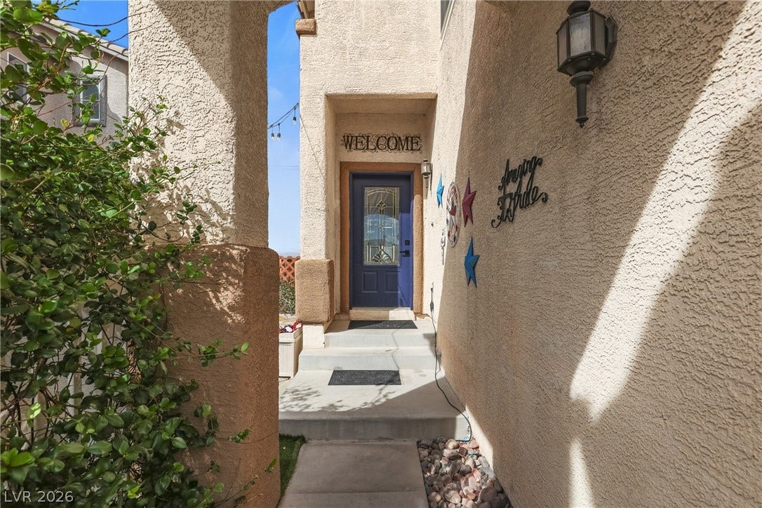7066 Shimmering Avenue, Henderson, NV 89011 An inviting stucco entryway leads directly to the front door through a private corridor.