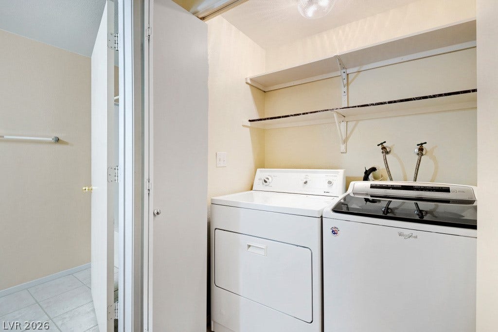 Functional utility space includes built-in shelving and tile flooring.