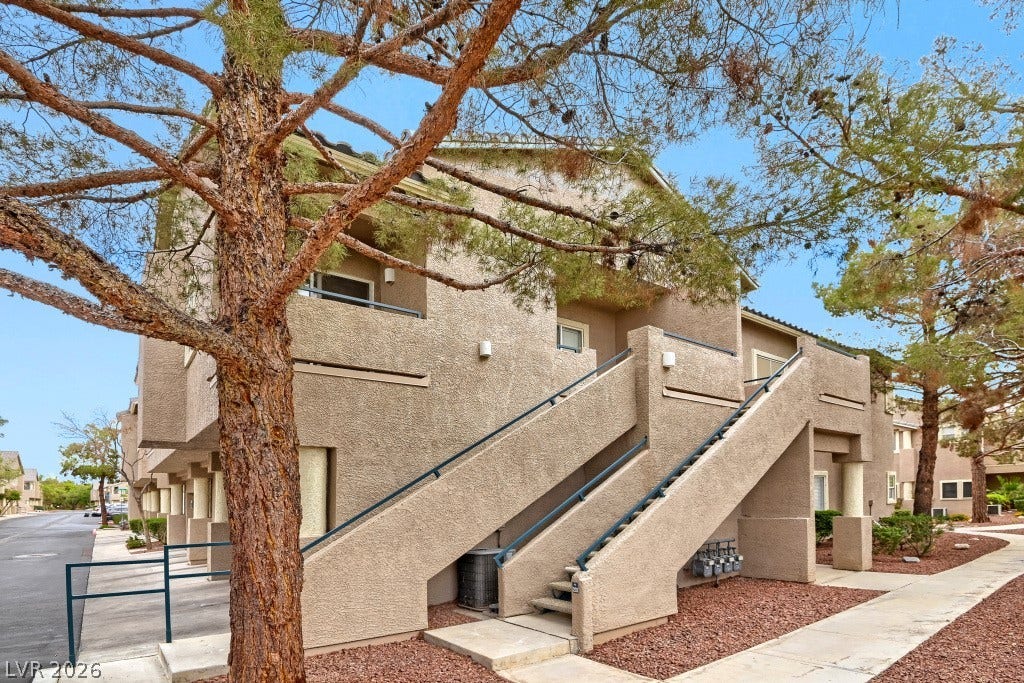 Stucco exteriors and concrete staircases define the architectural style of this residential complex.