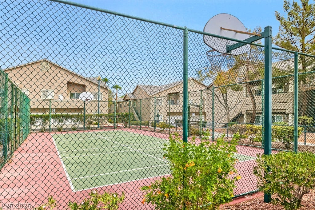 An enclosed outdoor sports court provides space for active recreation steps from residential buildings.