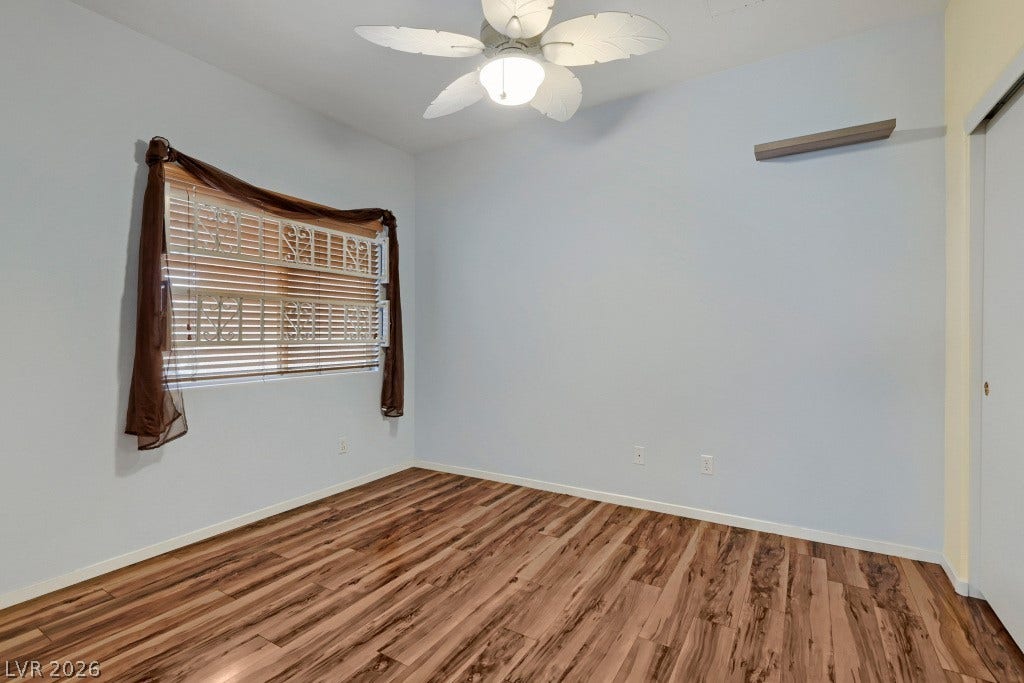 Rich wood flooring grounds this versatile space under smooth ceilings.